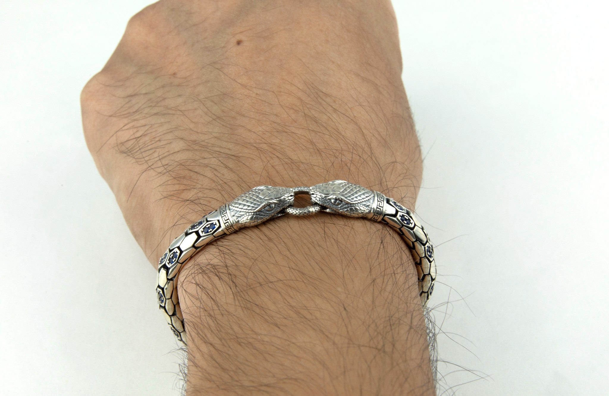 Double - Headed Snake bracelet by Miraura Jewels on a wrist against a white background