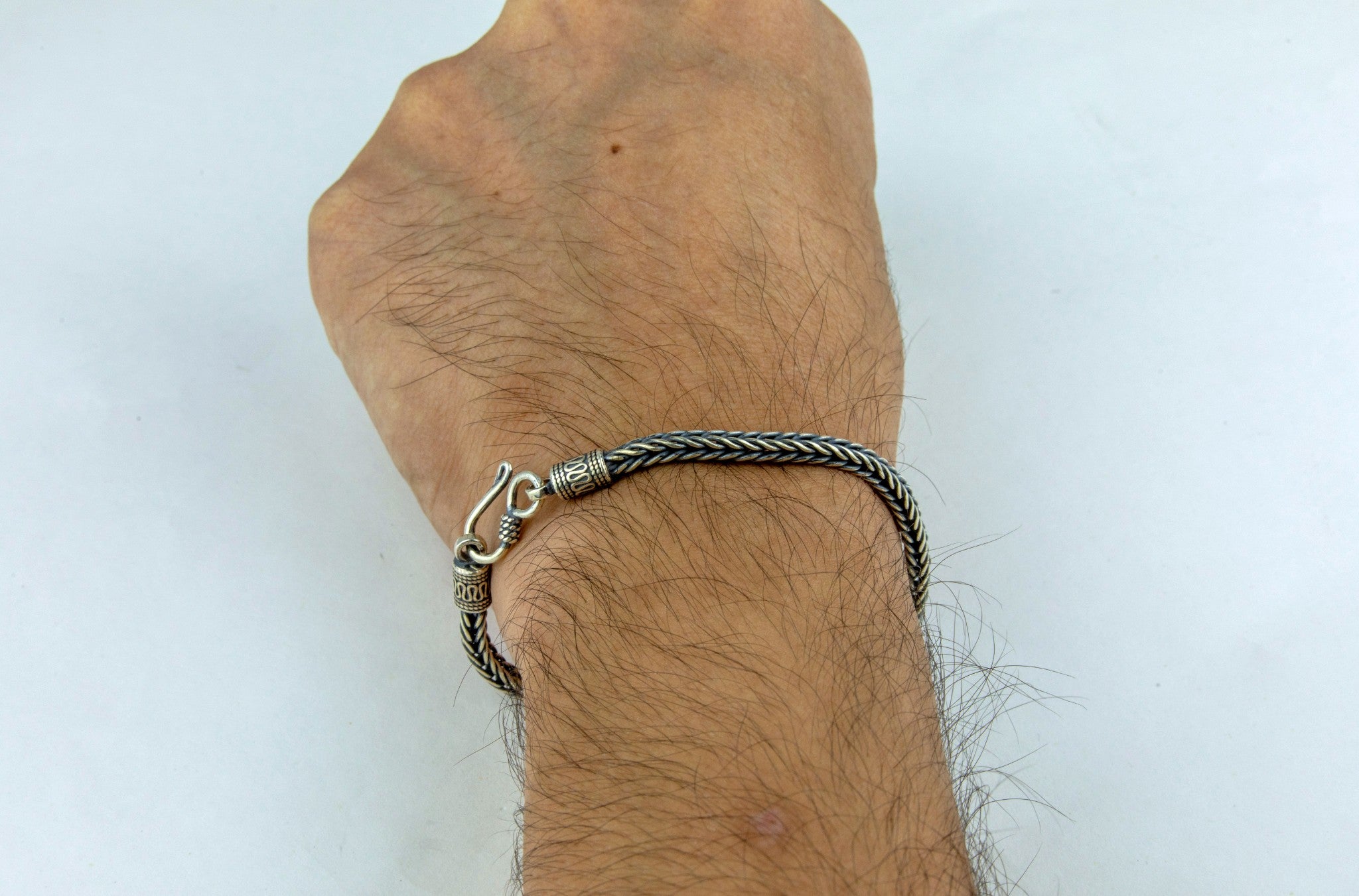 Men wearing Rugged oxidised foxtail-chain sterling silver men's bracelet on his wrist - Miraura Jewels