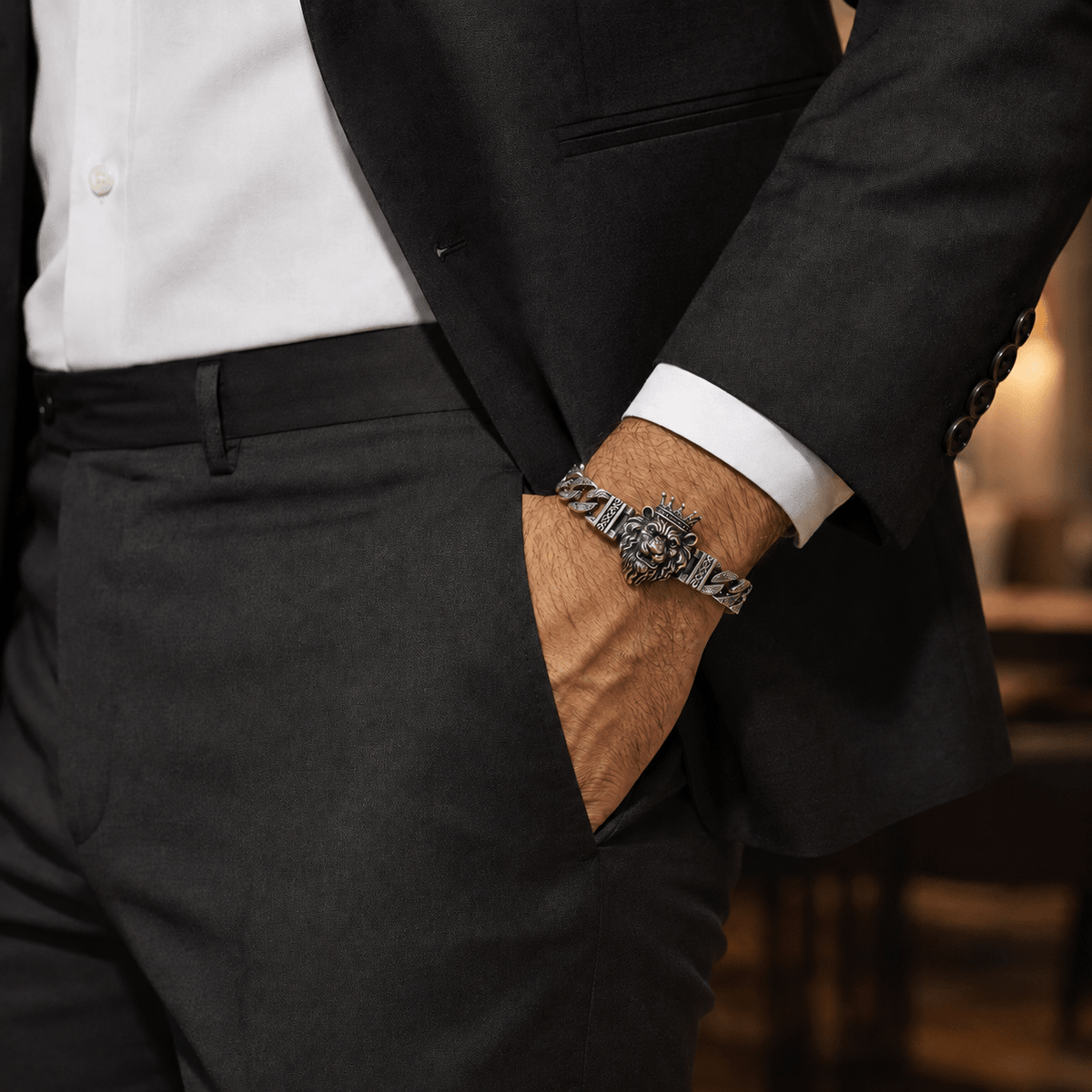 A close-up lifestyle shot of a man wearing a Lion Head Silver Curb Chain Bracelet by Miraura Jewels.