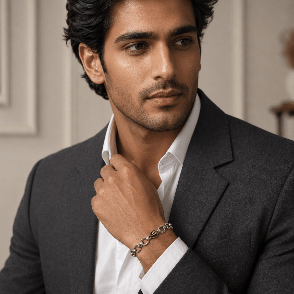 A man in a dark gray suit and white dress shirt wearing a 925 Sterling Silver Textured Gothic Link Bracelet - Miraura Jewels