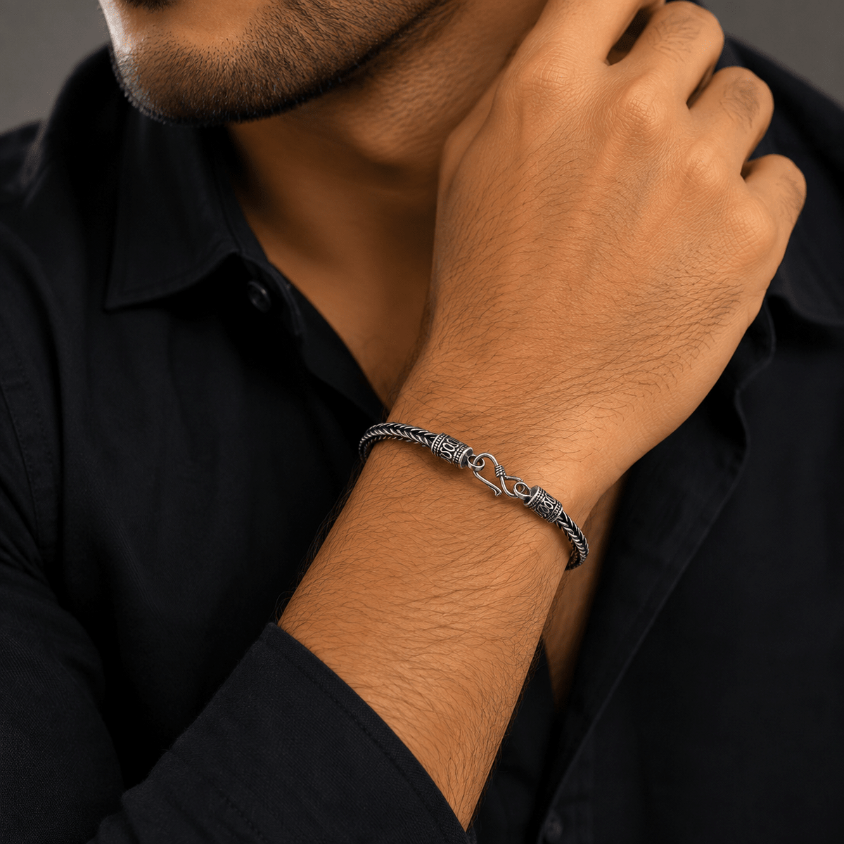 A close-up of a man wearing a 925 Sterling Silver Foxtail Link Bracelet