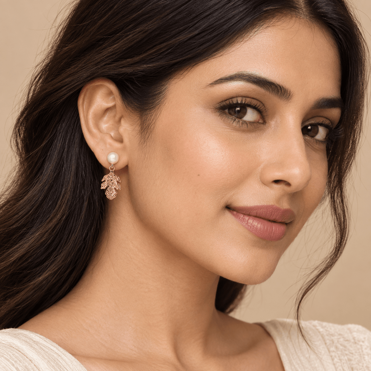 A woman wearing a 925 Silver Rose Gold Pavé Flower Stud Earrings by Miraura Jewels