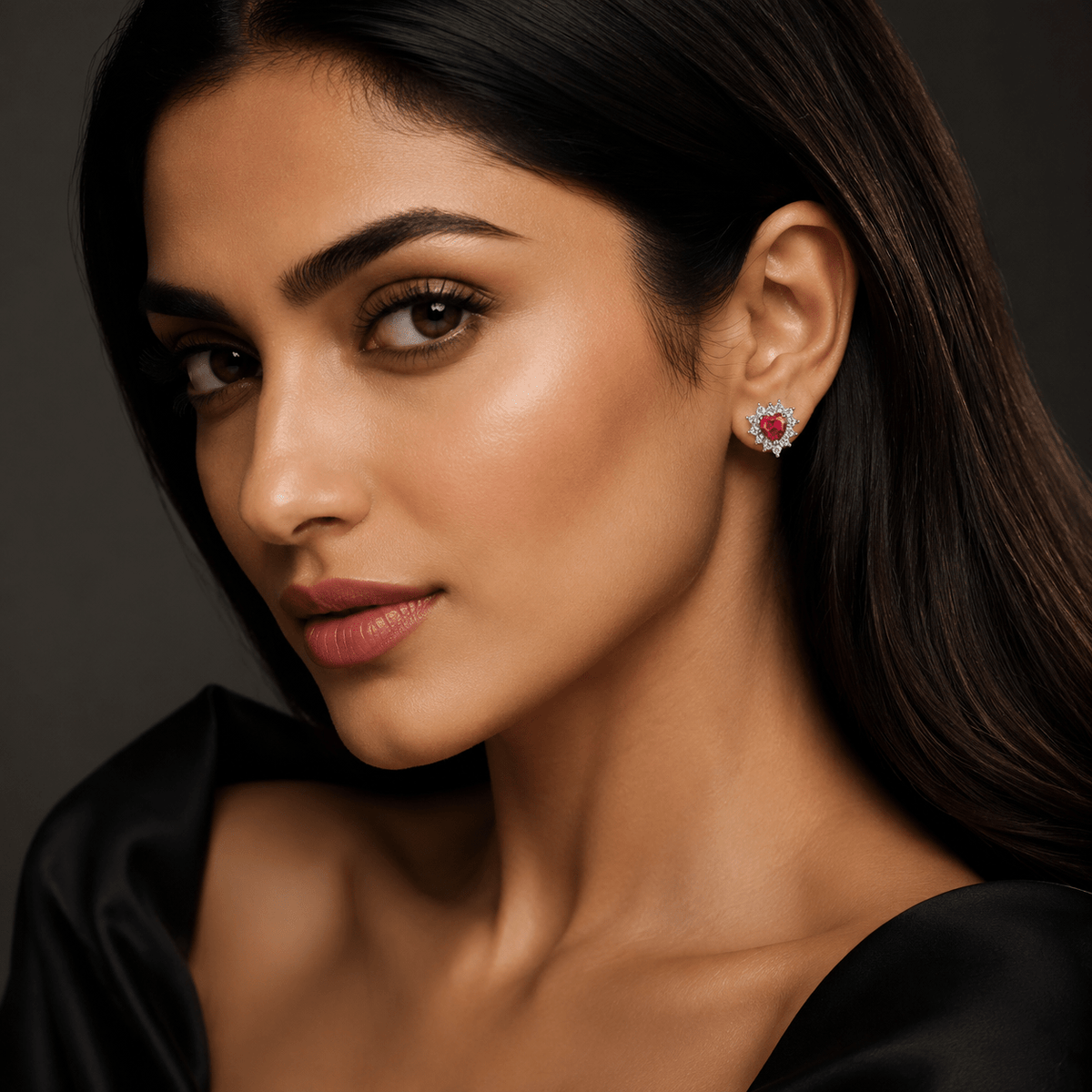 A beautiful girl wearing a small heart-shaped 925 Silver Ruby Heart Halo Stud Earrings | Miraura Jewels