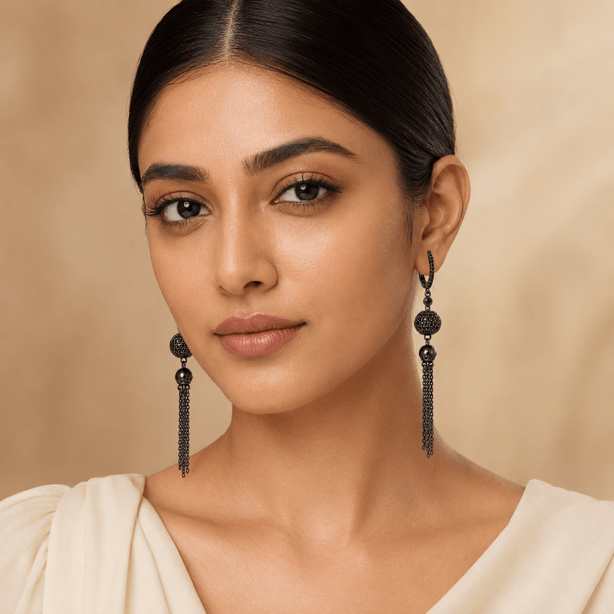 A young girl wearing long, dangling 925 Silver Black Rhodium Chain Tassel Drop Earrings | Miraura Jewels