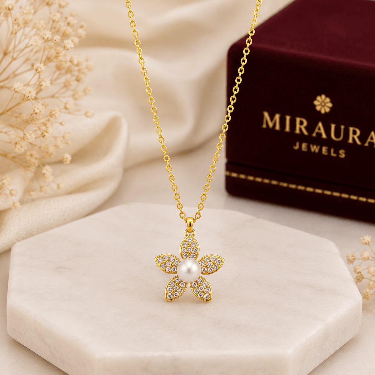 A Silver Pearl & Crystal Flower Pendant| Gold Finish. A dark red Miraura Jewels box is visible in the background 