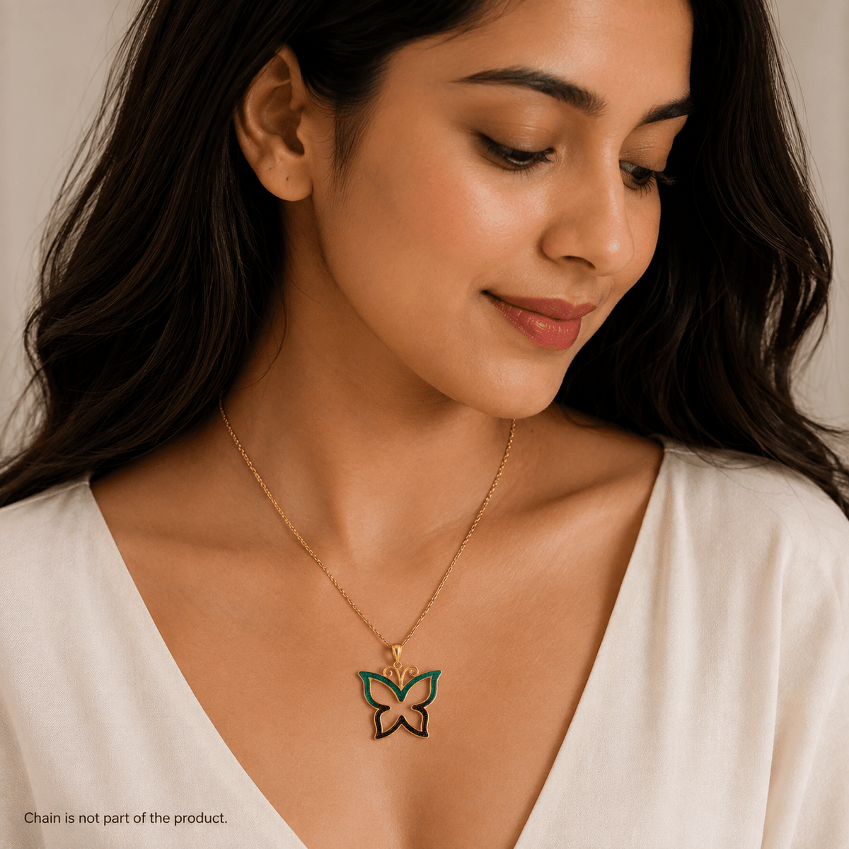 A woman wearing a delicate 925 Silver Enamel Butterfly Pendant by Miraura Jewels.The butterfly pendant features teal green and purplish enamel details.