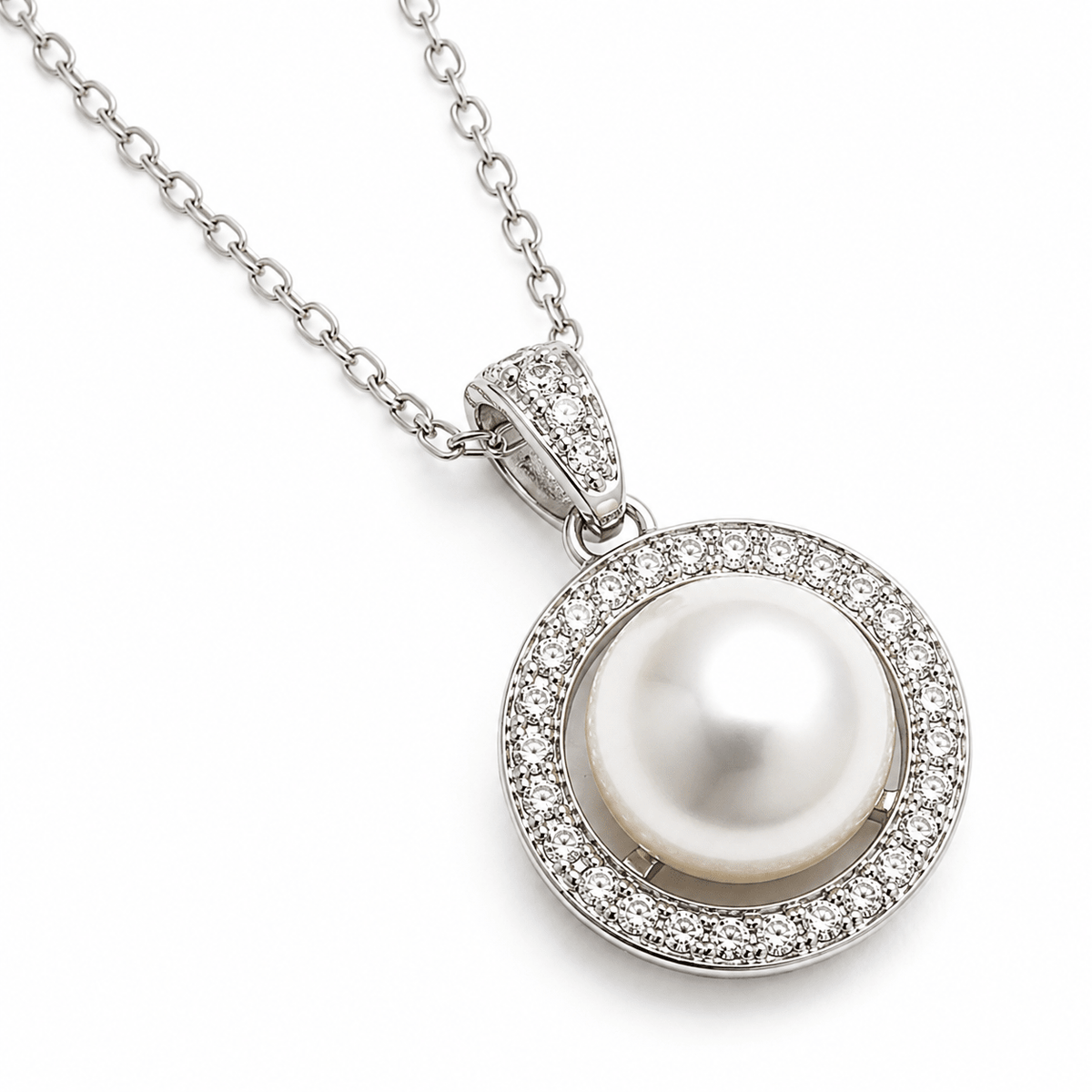 A silver pendant necklace featuring a central white pearl surrounded by a halo of small clear stones, suspended from a silver link chain on a white background.