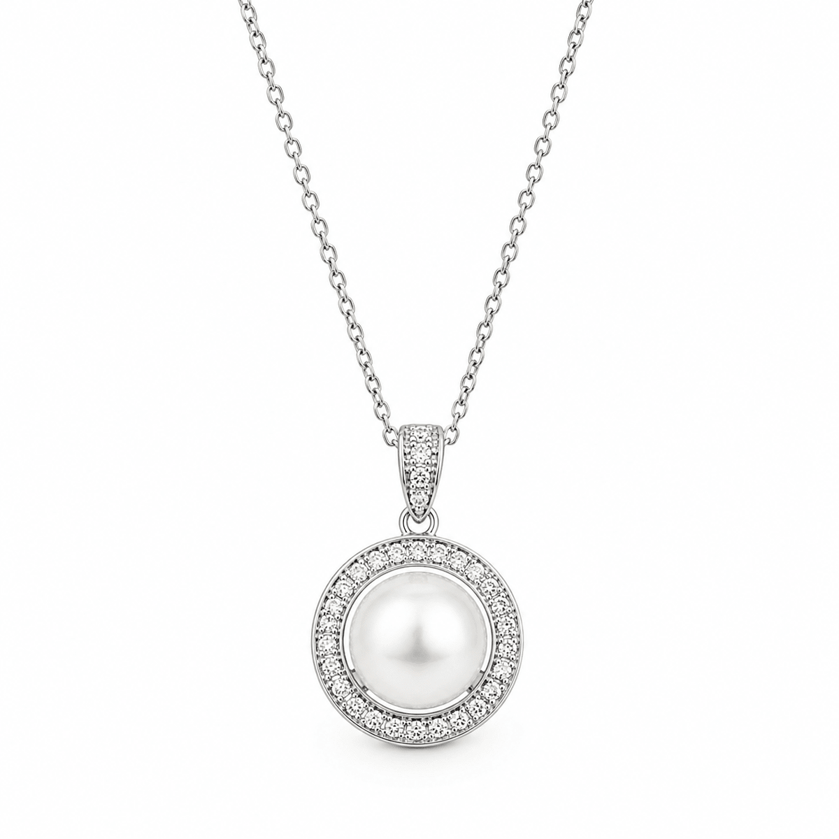 A silver pendant necklace featuring a central white pearl surrounded by a halo of small clear stones, suspended from a delicate silver chain on a white background.