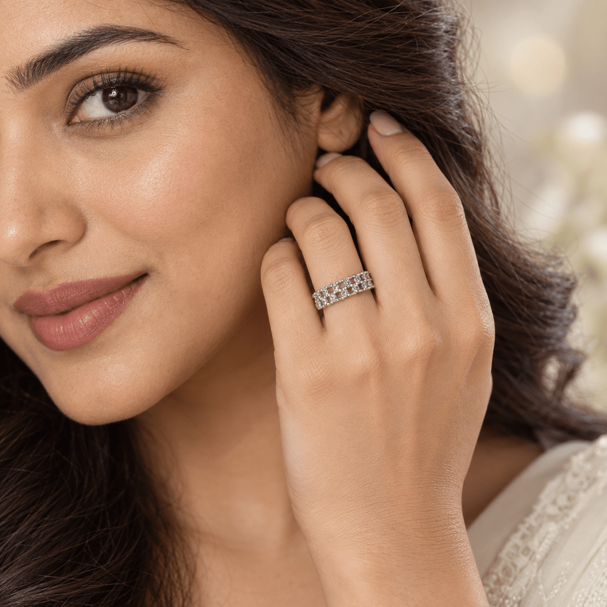 A close-up lifestyle shot of a woman wearing a 925 Silver Elegant Triple Row Eternity Band by Miraura Jewels