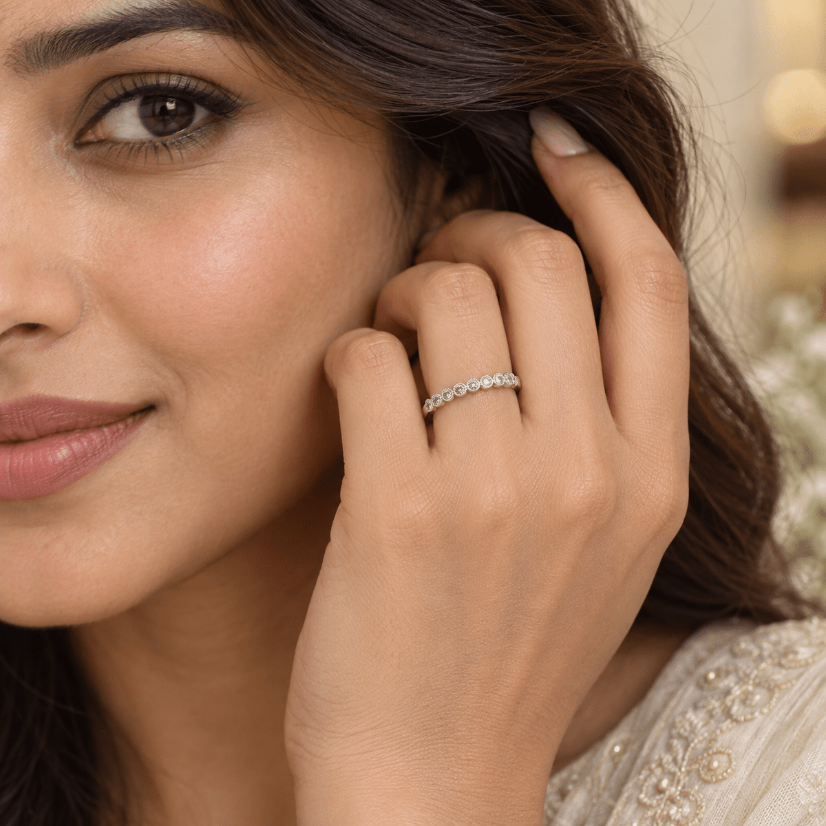 A close-up lifestyle shot of a woman wearing a delicate 925 Sterling Silver Half Eternity Wedding Band with Round Stones