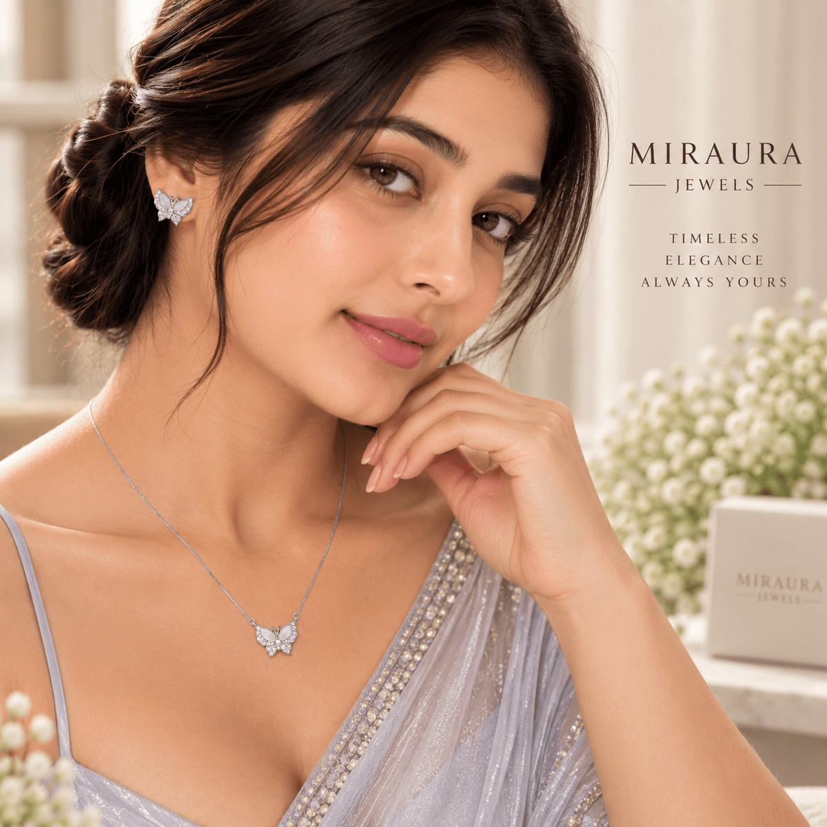 A woman wearing a Miraura Jewels silver butterfly pendant necklace and matching butterfly stud earring, styled in a soft, elegant indoor setting with floral decor and brand text on the right.