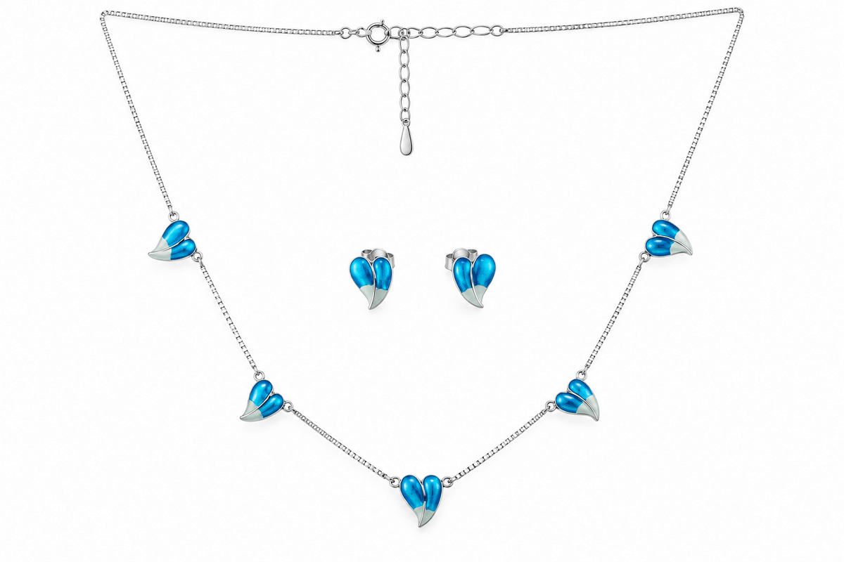 Silver-tone chain necklace and matching stud earrings set, each decorated with three small heart charms featuring bright blue enamel and white enamel detailing, shown on a plain white background.