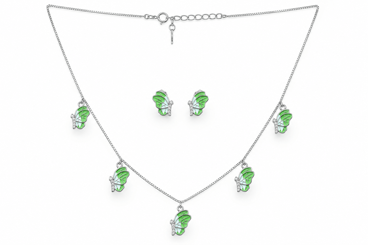 A silver-tone jewelry set featuring a necklace and matching earrings, each adorned with a small green fairy charm with clear rhinestone accents, displayed on a clean white background.