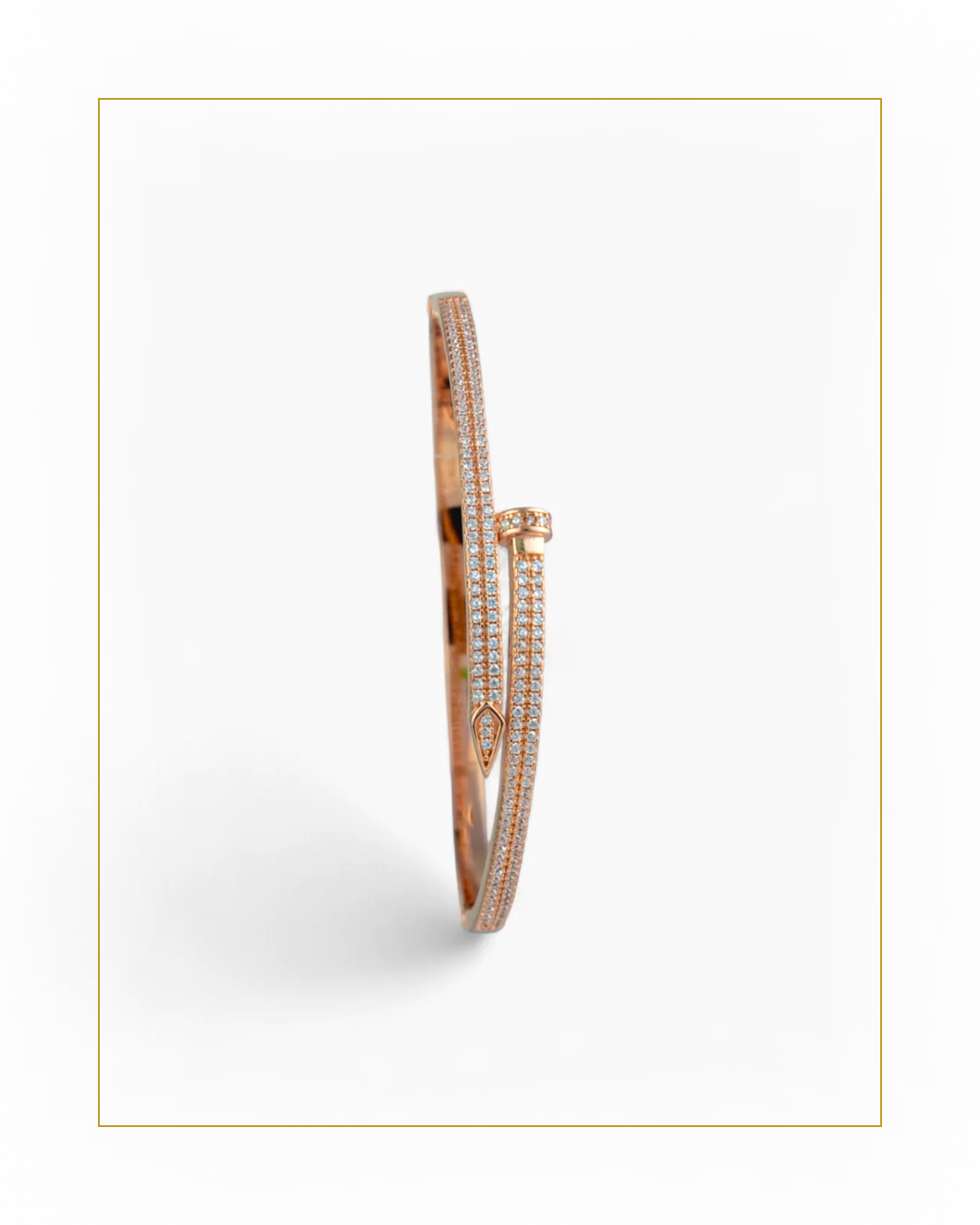 Rose gold bracelet with diamond accents on a white background