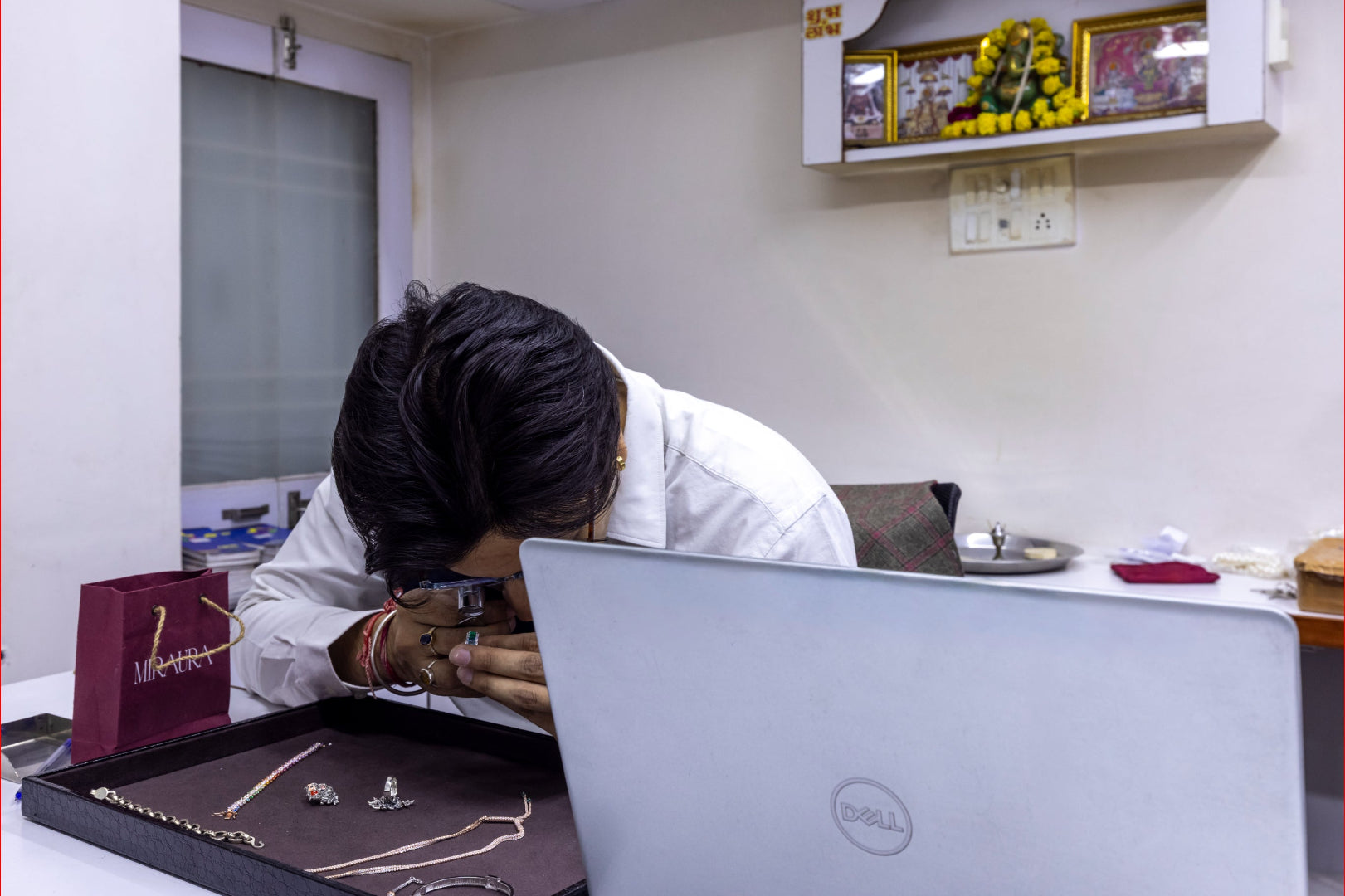 Ratnesh Pansari working on a laptop in Miraura office setting with jewelry, doing QC of our 925 silver Jewellery.