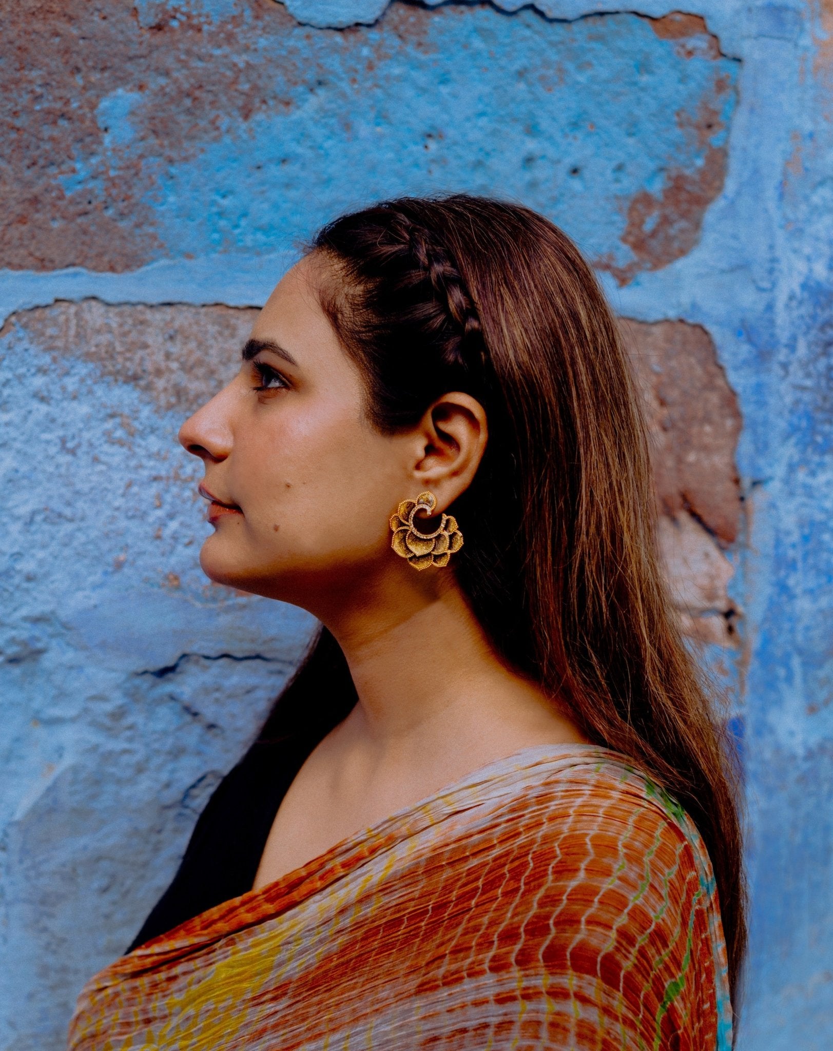 Girl wearing a Textured Gold Enamel Floral Hoop Earrings by Miraura Jewels
