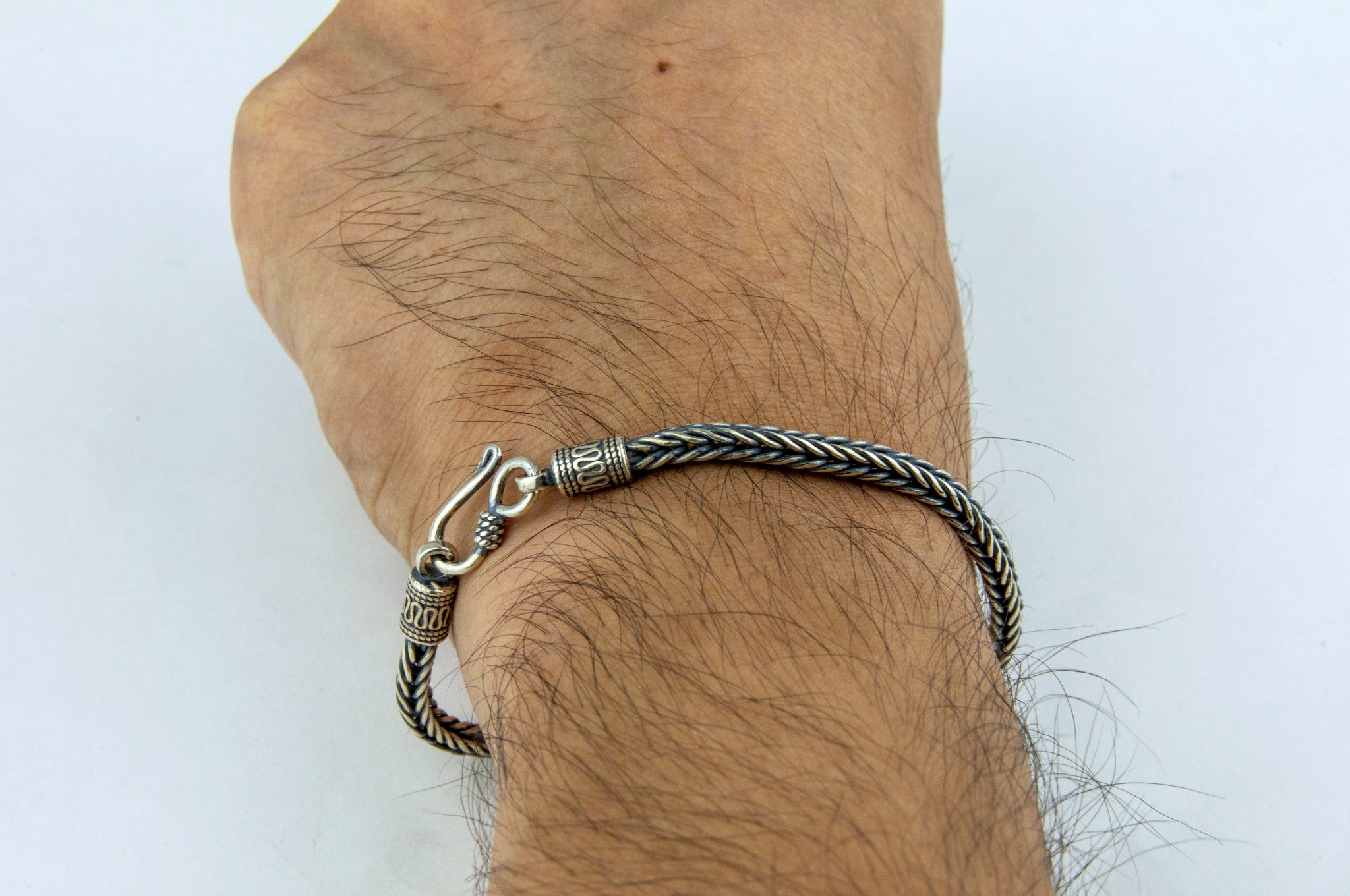 Man wearing Rugged oxidised foxtail-chain sterling silver men's bracelet by Miraura Jewels