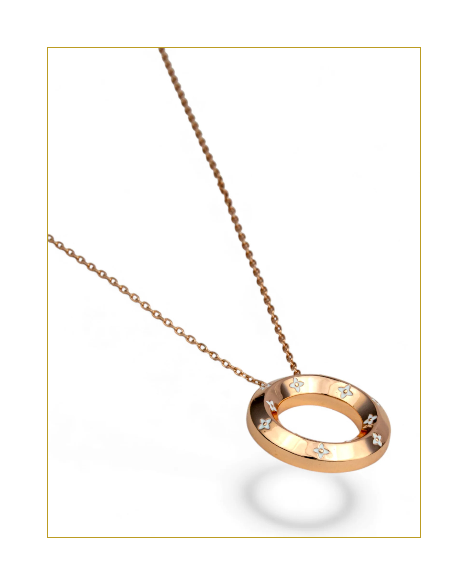 Rose gold necklace with a circular pendant on a white background