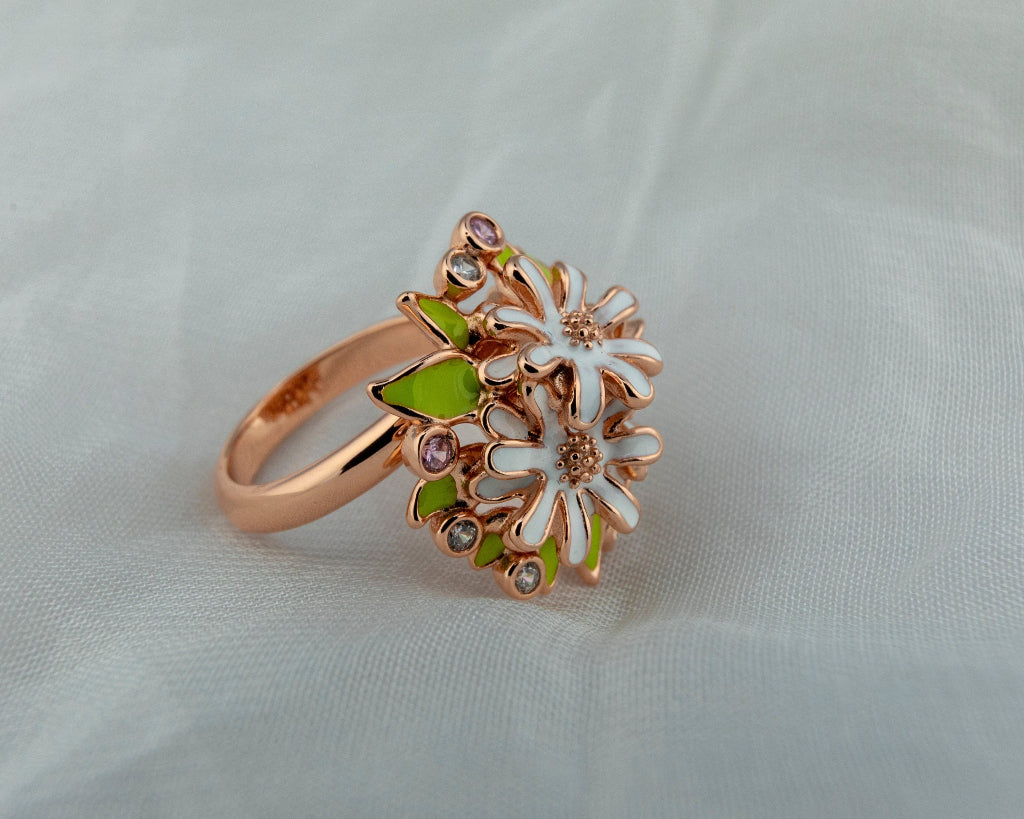Rose gold ring with floral design on a light gray background by Miraura Jewels